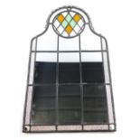 A 20thC lead glass mirror, with colour glass diamond shaped upper section and panels beneath, of sha