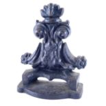 An early 20thC cast iron door stop or porter, of scroll design on serpentine base, 23cm high.