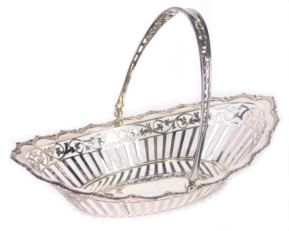 A George V silver basket, by James Dixon, of oval form with pierced swing handle, pierced body, deco