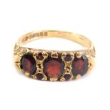 A 9ct gold dress ring, set with four large and four small garnets, size K.