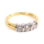 An 18ct gold three stone diamond ring, on plain shank, size M, 3.4g all in.