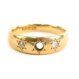 An 18ct gold dress ring, inset with two small white stones (one lacking) size L, 3.9g all in.
