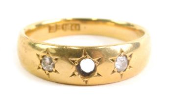 An 18ct gold dress ring, inset with two small white stones (one lacking) size L, 3.9g all in.