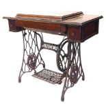 A Singer treadle sewing machine, in walnut and iron case, 92cm wide.