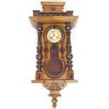A 19thC walnut Vienna wall clock, the 13cm diameter Roman numeric dial stamped Junghans, flanked by