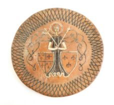 A 17thC style slipware charger, with a lattice work border, figure and two shield decoration and pud