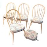 A set of four Ercol beech and light elm stick back dining chair, each with a hoop back, solid seat o