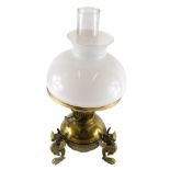 An early 20thC brass oil lamp, with clear glass chimney, milk glass shade and brass reservoir, stamp