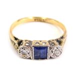 An 18ct gold dress ring, with baguette cut blue stone flanked by two small diamonds, size J, 2.3g.