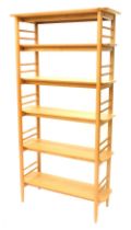 An Ercol oak 3671 Teramo open shelving unit, with turned supports, 186cm high, 94cm wide.