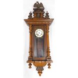 A 19thC walnut cased Vienna wall clock, the 12cm diameter dial with Roman numerals, fronted by an ar