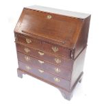 An 18thC oak bureau, the fall enclosing a fitted interior above two short and three long drawers, ea