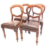 A set of four Victorian mahogany balloon back chairs, each with a drop in seat, on turned legs.