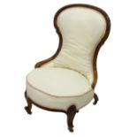 A Victorian walnut nursing chair, with a show frame, a padded back and seat, on cabriole legs with c