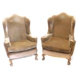 A pair of mahogany wing back chairs, upholstered in brown fabric on cabriole legs.