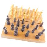 A 20thC carved wooden chess set, with 10cm high white king, in box inset with board.