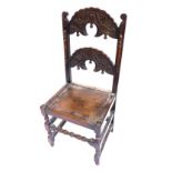 An oak Yorkshire type side chair, the double arched back carved with scrolls, leaves, etc., and with