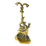 A 20thC brass door stop, with serpentine front, the back plate set with deer with sprouting leaf top