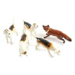 Four various Beswick hounds, and a Beswick fox, 5cm high, printed marks beneath.