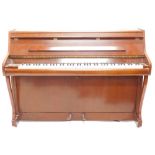 A low mahogany upright piano by Bentley, 99cm high, 138cm wide.