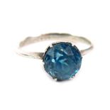 A dress ring, claw set with blue zircon, size N.