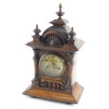 A late 19thC walnut mantel clock, with three urn finials, dome top, shell inlay, 10cm diameter Arabi