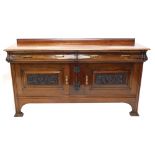 An early 20thC walnut sideboard, with two cushion frieze drawers above a pair of heavily carved pane