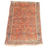 A Persian rug, with an all over geometric design on a red ground with three narrow borders, 118cm x