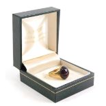 A 9ct gold dress ring, inset with red stone, size G, 5.3g all in.