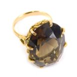 An 18ct gold dress ring, claw set with large citrine coloured stone, size N, 11.6g all in.