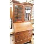An oak bureau bookcase, with glazed top.