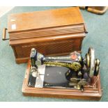 A Singer sewing machine in a walnut case.