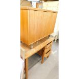 A teak side cabinet on chrome legs, and a single pedestal office desk.