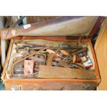 A pressed leather travel case, containing a quantity of various tools, jack, wood plane, heavy lock,