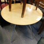 A modern circular cafe table, with chrome plated legs, 73cm high, 81cm diameter