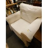 An armchair, with white canvas cover.