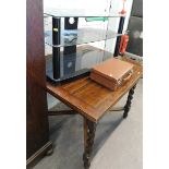 A glass three tier television cabinet, oak draw leaf table, and leather travelling case.