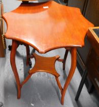 An Edwardian mahogany two tier table, the shaped octagonal top on splayed supports with concave unde