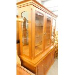 A light mahogany door display cabinet, with triple cupboard beneath.