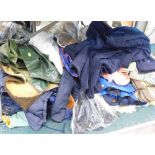 A large quantity of clothing, jackets, fur lined and others, various vintage clothing material, etc.