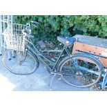 A Ladies Raleigh bicycle, with front basket, chrome mounts, black leather seat with springing and g