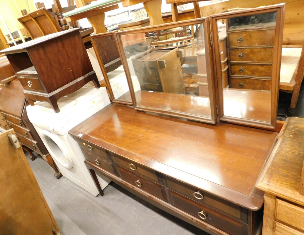 A Stag mahogany dressing table, and a bedside cabinet. (2)