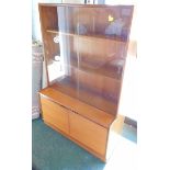 A retro teak bookcase, with two sliding doors and two doors with piano hinges on a plinth, 139cm hig