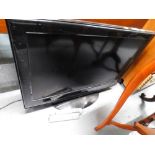 A Tevion 32" flat screen television, in black trim with wire and remote control.