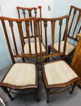 A set of four Edwardian mahogany bedroom chairs, each with boxwood strung borders and a padded seat