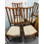 A set of four Edwardian mahogany bedroom chairs, each with boxwood strung borders and a padded seat