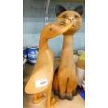 A modern treen duck figure and another of a standing cat.