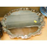A large silver plated salver, with pie crust outline.