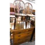 An oak chest of two short and three long drawers, and two Windsor chairs.