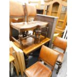 An oak draw leaf table and four chairs.